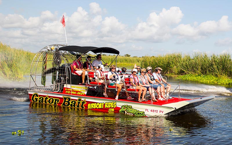 Tourist on board Gator Bait Airboat Adventures as they cruise Blue Cypress Preserve in Vero Florida.